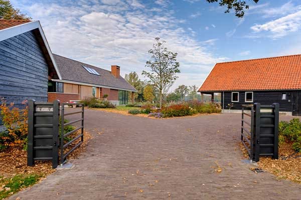Erftoegang met eiken poorten tussen boerderij en schuur